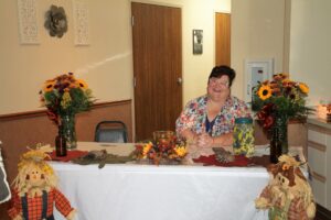 a person sitting at a table with flowers